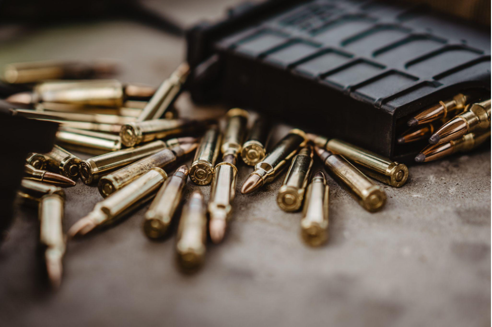 bullets scattered along with a magazine filled with bullets